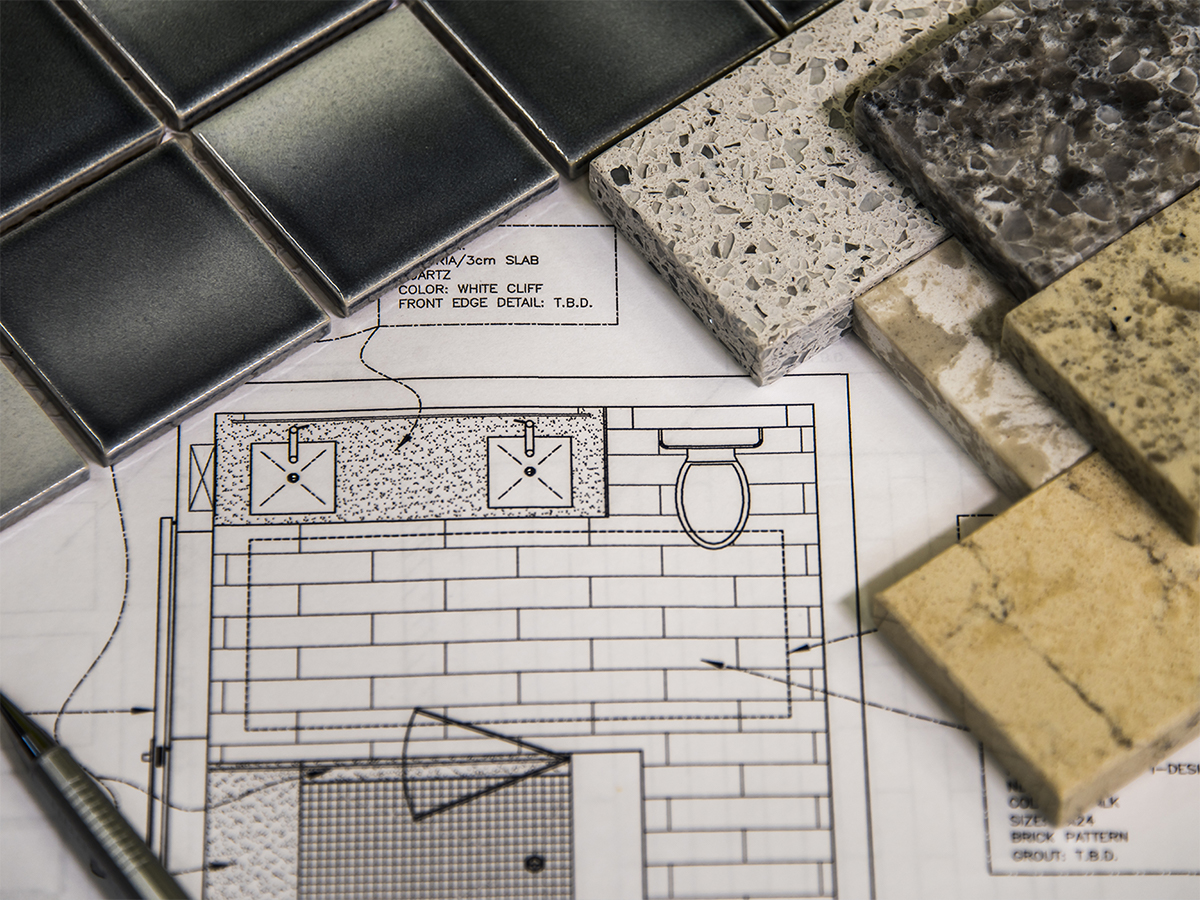 various tiles surrounding blueprints for a bathroom